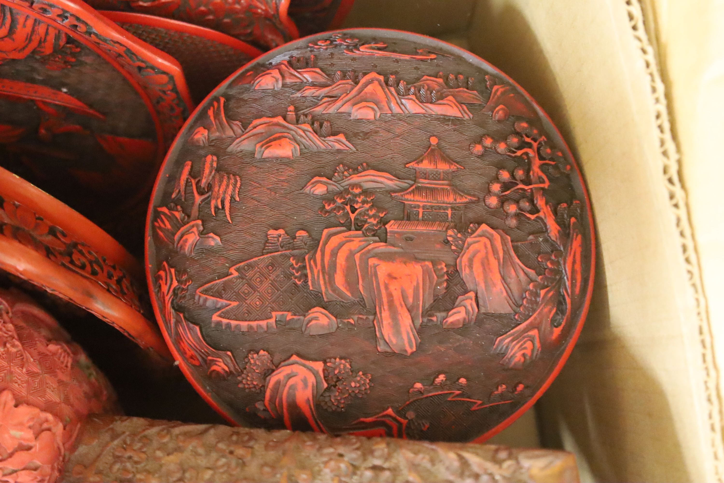 A quantity of red lacquer boxes and other ornaments